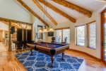 Large pool table room with a view off the bar and entertaining space.